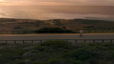 Man on longboard ride empty road at sunset Stock-Footage 145845806