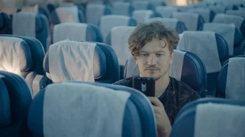 Man Look At The Cellphone On Plane Vídeo Stock 94470573