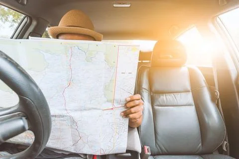 Man look at the map inside car Fotos Stock