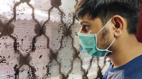 Man look outside closed window 스톡 사진