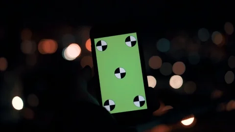 The man look on the Smartphone green screen. night city Stock Footage 100558591
