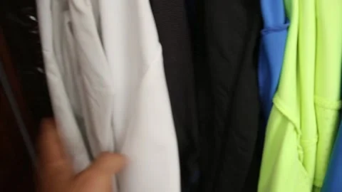 A man look for some clothes inside a messy wardrobe Stock Footage 239549070