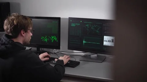 The man, looked like a hackers trying to enter on the keyboard of a computer Stock Footage 72425521
