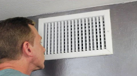 Man Looking in an Air Vent Stock Footage 60546069