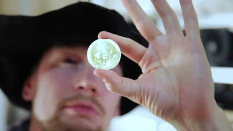Man looking And checks the coin for authenticity 動画素材 87043335