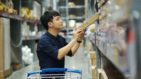 Man looking and shopping in the warehouse store Stock Footage 141489926