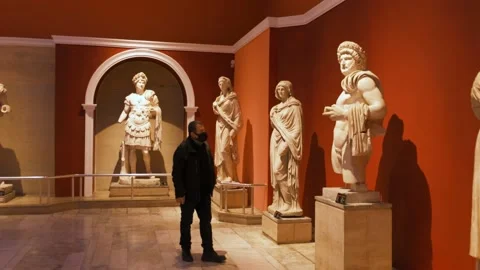 Man looking at the antique sculptures Stock Footage 168686944