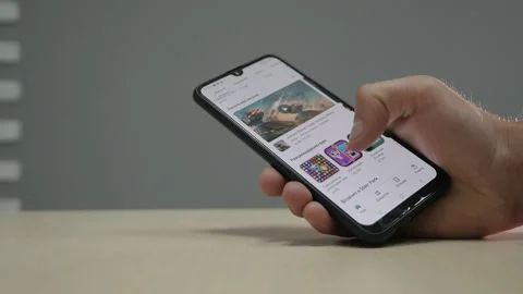 Man looking for applications on the phone Stock Footage 163717557