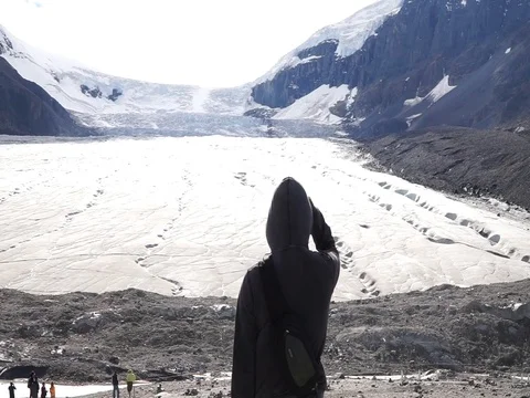Man looking at the Athabasca Glacier in Jasper National Park, Canada. Stock Footage 100220158