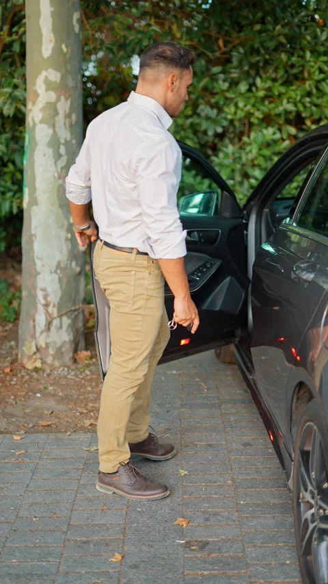 Man looking away and getting into car Stock Footage 234361237