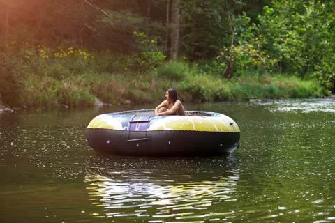 Man looking away while sitting in inflatable boat Stock Photos