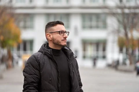 Man looking away while standing outdoors on the street. Foto stock