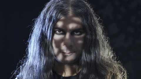 Man looking badly at camera in front of black backgorund. 스톡 동영상 227533879