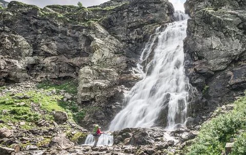 Man looking at big waterfall 스톡 사진