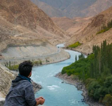 Man looking at blue river Stock Photos