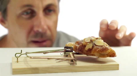 Man Looking at Bread In Mouse Trap Stock Footage 66461474