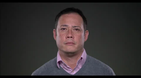 Man looking at camera and opening eyes, smiles Stock Footage 22583642