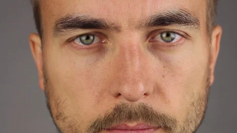 Man looking at the camera and rubs the bridge of his nose, front view, closeup Video stock 94364243