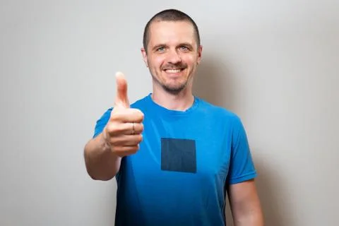 Man looking in camera and show thumbs up Stock Photos