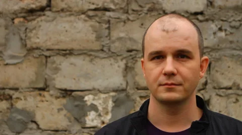 Man looking into the camera and then looks in the direction of Stock Footage 50129585