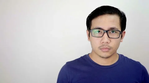 Man Looking at Camera Close up Portrait on White Background in Studio Slow Mo Stock Footage 59949383