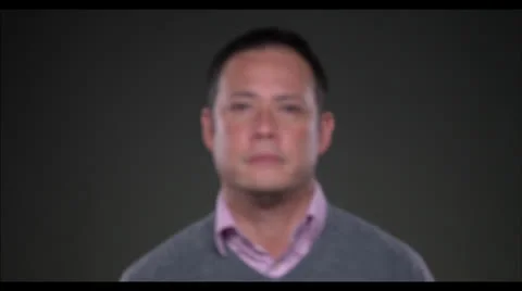 Man looking at camera focus pull and opening eyes Stock Footage 22590809