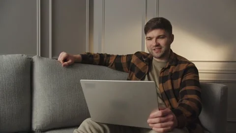 Man looking at camera, holding conversation with team online. Programmer male Stock Footage 229718570