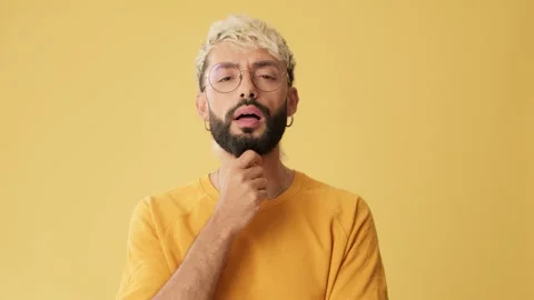Man looking at camera listens carefully and agrees, isolated on yellow Stock Footage 254914446