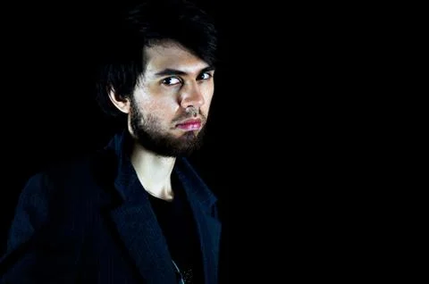 Man looking at the camera with a serious expression Stock Photos