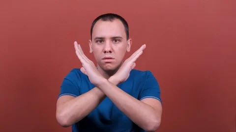 Man Looking at the camera showing stop gesture. man emotion isolated.  Stock Footage 123017301