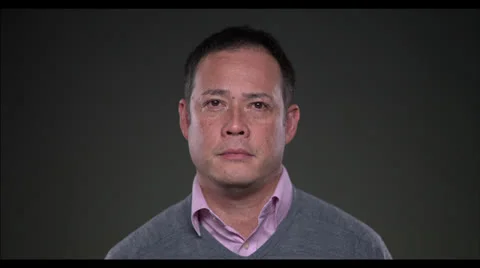 Man looking at camera smiles Stock Footage 22584486