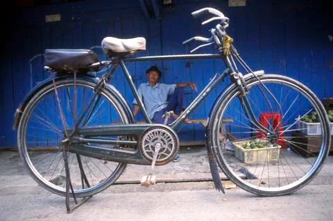 Man looking at the camera through the bicycle indonesia Stock Photos