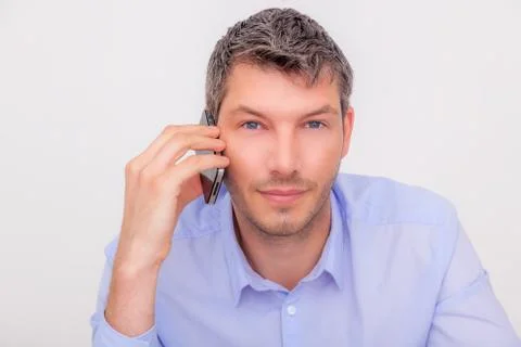 Man looking camera while phone on ear Stock Photos