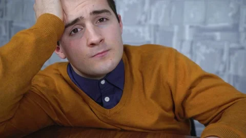 Man looking at the camera while sitting at a table Stock Footage 167180889