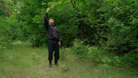 Man looking for a cellular connection in forest. Problems with Internet Stock Footage 158143077