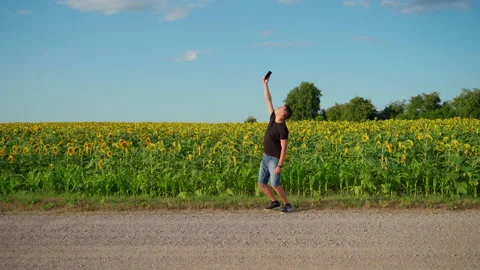 Man looking for cellular Internet connection on rural road Stock Footage 157691005