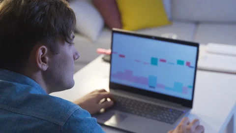 A man looking at the charts of cryptocurrency exchanges on his PC screen. Stock Footage 218962265