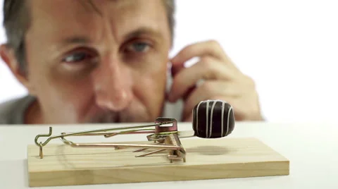 Man Looking at Chocolate In Trap Stock Footage 66484640