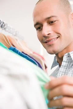 Man looking at clothes Stock Photos