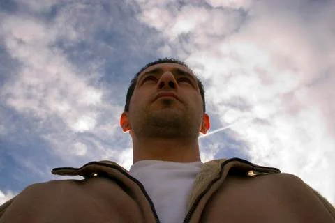 Man looking up with the clouds on the background Stock Photos