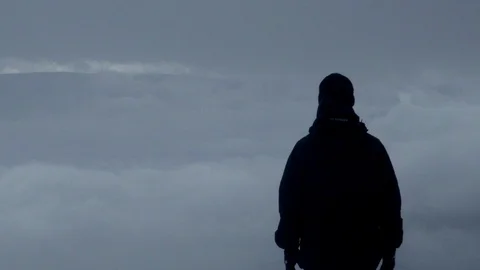 Man looking at clouds on the top of mountain Stock Footage 86691565