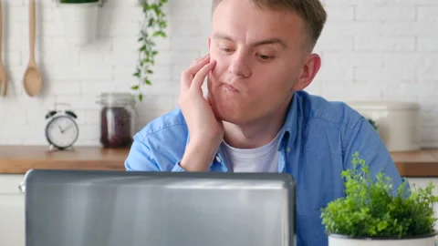 A man looking at a computer screen and is nervous and worries from what he saw Stock Footage 128249994