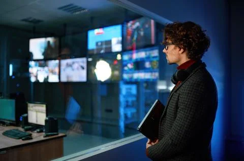 Man looking at computer screen reflection in server room window Stock Photos