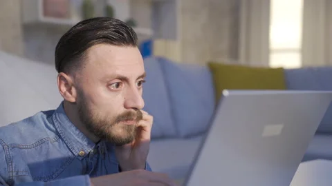 Man looking at computer screen is working very carefully. 스톡 동영상 230937067