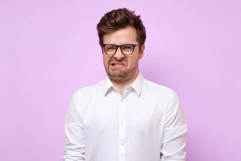 Man looking in contempt, feeling loathing and disgust towards something Stock Photos