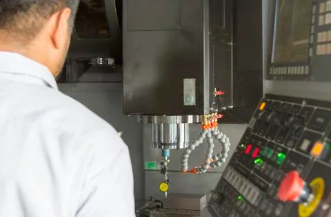 Man looking for dial gauge for setting balance work   after cutting of CNC Stock Photos