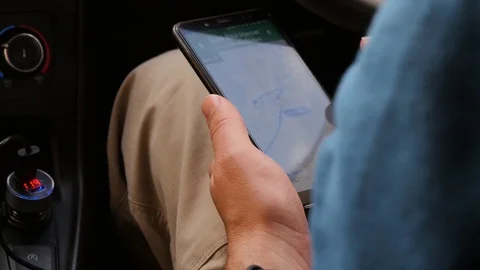 A man is looking for directions on the map in the phone, starts to go to the Video stock 101201753