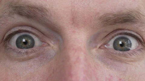 The man, looking directly into the camera, feigns surprise. Stock Footage 276645732