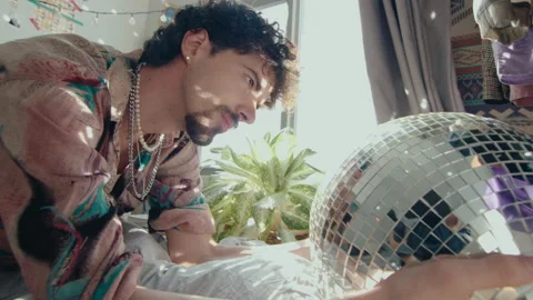 Man Looking at Disco Ball Lights in Bedroom Stock-Footage 235658773