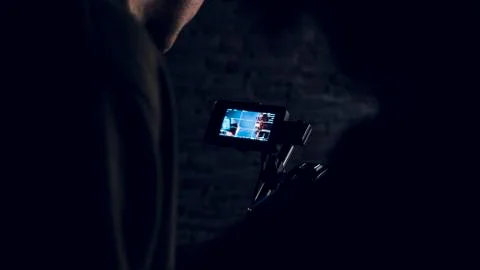 Man is looking on the display of the camera 스톡 사진